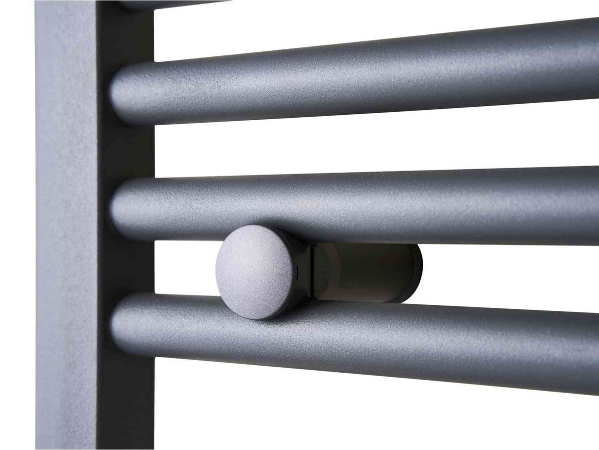 Close-up of a modern, silver-colored electric towel radiator with horizontal bars and a rounded control knob, designed for bathroom heating.