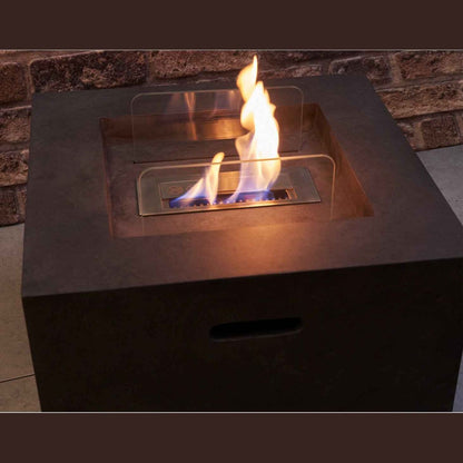 Close-up view of the Field and Flame Cassia bio ethanol fire pit burning brightly with its real adjustable open flame flame tray exposed.